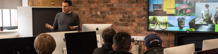 Students working on Macs in classroom